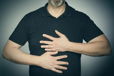 Hands of man's face in studio in black shirt when trying expressions Stock Photos