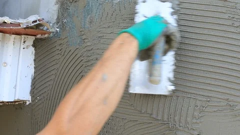 Hands of an manual worker with wall plastering tools renovating house, close up Stock Footage 91493153
