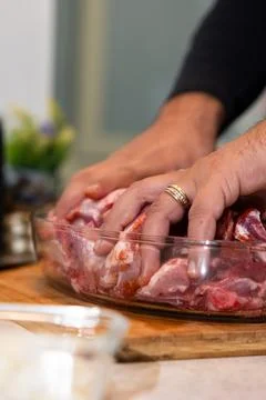 Hands marinating raw meat for cooking preparation Stock Photos