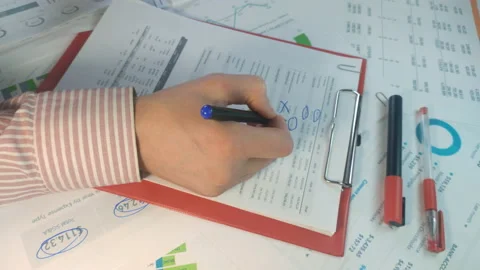 Hands marking data in a business report Stockbeeldmateriaal 170513585