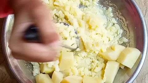 Hands Mashing Boiled Potato Chunks in Metal Plate, Cooking Prep, Stock Footage 329094755