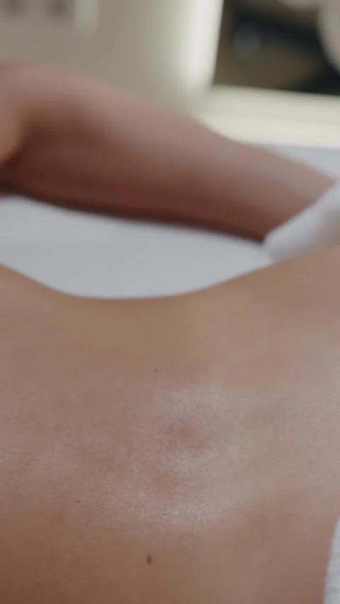 Hands massaging lower back during spa session Video stock 312525671