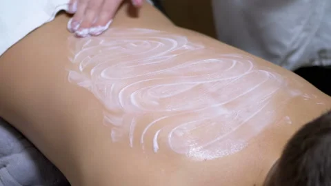 Hands of the Masseur are Massaging Back a Child Using Cream. Zoom. Close up Stock Footage 166687901