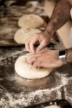 Hands of the master baker in bread production Foto stock