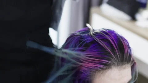 Hands of master combing colourful hair. Stock Footage 277678894