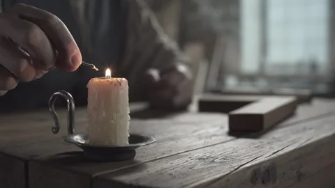 Hands of a master dipping the knotted end of a linen cord into melted wax Stock-Footage 339631552