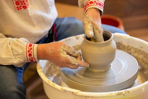 The hands of the master make a pot of clay. Stock Photos