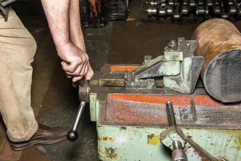 Hands of the master make repairs in the machine shop. Stock Photos