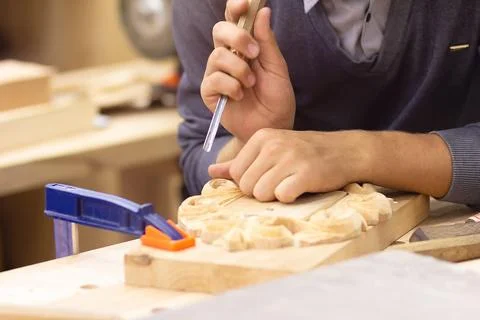 Hands of a master making hand-carved wood Stock Photos