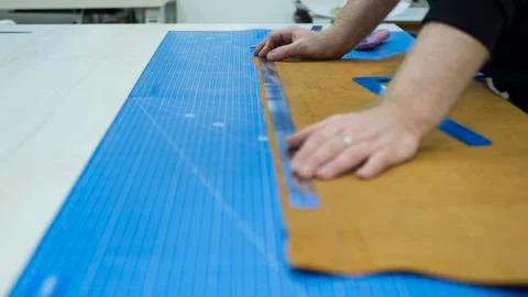 Hands of the master. Marking leather for making bags, purses or shoes. Stock Photos