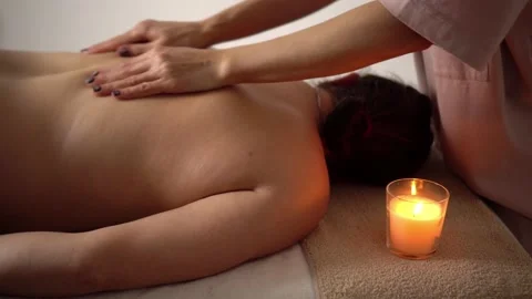 Hands of master of masage massage back of woman lying on couch on table Stock-Footage 221434717