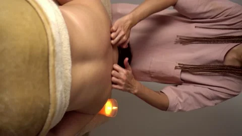 Hands of master of message massage back of woman lying on couch on table Stock Footage 221434739