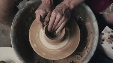 Hands of the master potter and vase of clay on the potter's wheel close-up Stock Footage 78075457