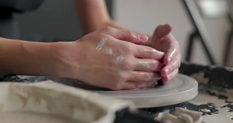 Hands of a master potter working on a potter's wheel, forming a bowl of clay 스톡 동영상 155814577