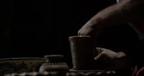Hands of a master potter working on a potter's wheel in the manufacture of Stock Footage 255697399