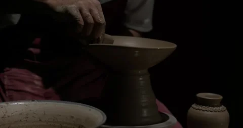 Hands of a master potter working on a potter's wheel in the manufacture of Stock Footage 257390871