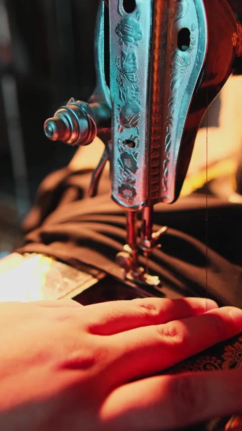 Hands of a master sewing clothes on a hand sewing machine in an atelier. Stock Footage 308634970