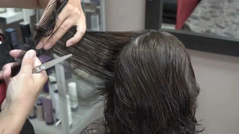 The hands of a master stylist close-up. He combs and cuts the hair of a client  스톡 동영상 111902270