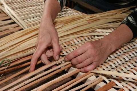 Hands mastering wicker fabric Stock Photos