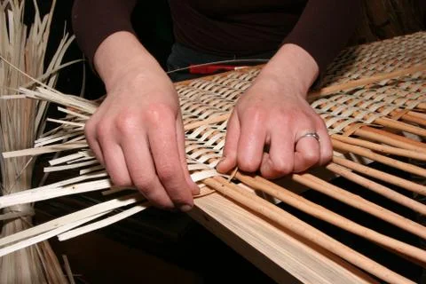 Hands mastering wicker fabric Stock Photos