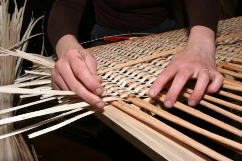 Hands mastering wicker fabric Stock Photos