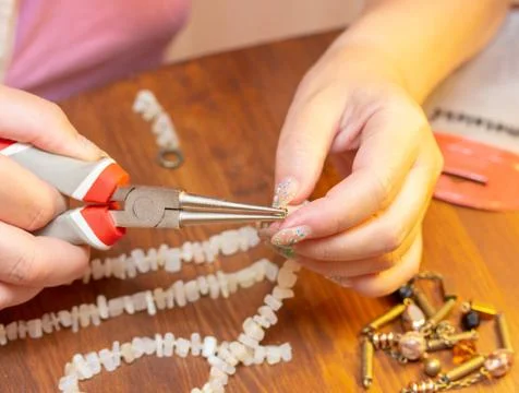 Hands masters for interesting work-the creation of beads Stock Photos