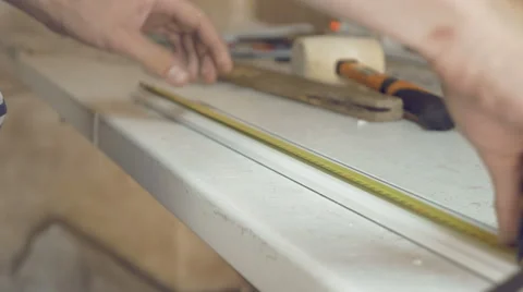 Hands measuring and setting mark on aluminum Stock Footage 66290919