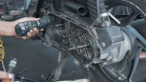 Hands of a mechanic cleaning automatic motorcycle spare parts Stock Footage 234465423