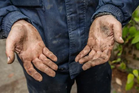 Hands of a mechanic soiled by engine oil Stock Photos