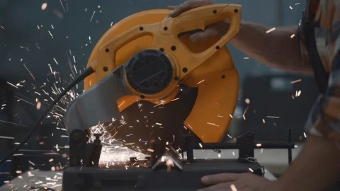 Hands of mechanic using electrical angular grinding machine at factory Stock Footage 93159587