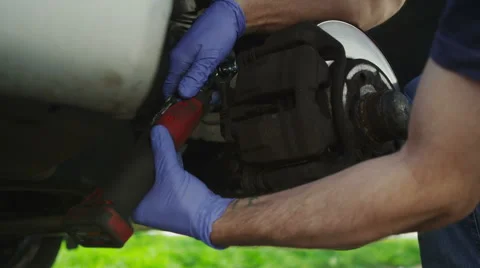 Hands of a mechanic working on brake pads on a car 库存影片 49241127