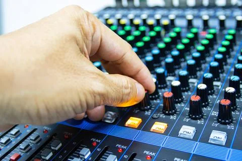 Hands of Men are controlling the console of a large hi-fi system Photos