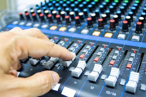 Hands of Men are controlling the console of a large hi-fi system Photos