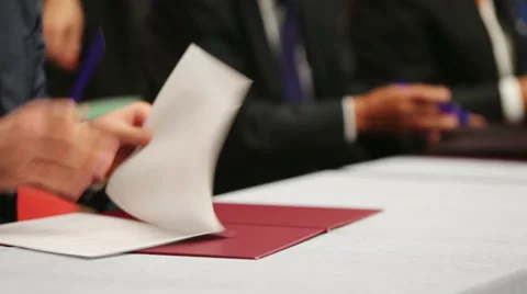 Hands of men at table sign documents at business meeting Stock-Footage 38164611