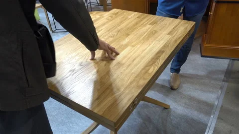 Hands of men touch of a wooden table in 4K Stock Footage 124751783
