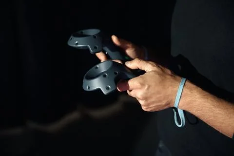 In the hands of men two virtual reality controllers, game Stock Photos