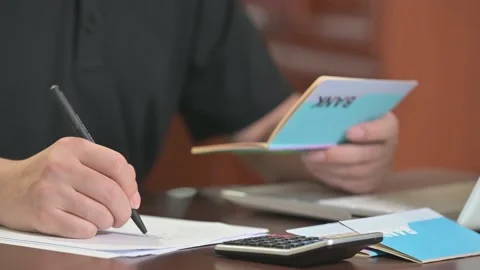 The hands of the men who are holding a bank passbook and weaving a budget. Stock Footage 136723155