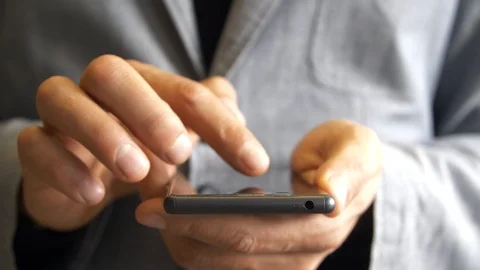 Hands of men work through the touchscreen smartphone Stock Footage 104493890