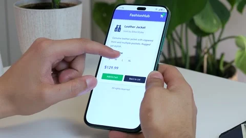 Hands meticulously select a leather vest from an online marketplace, carefully Stock Footage 315430659