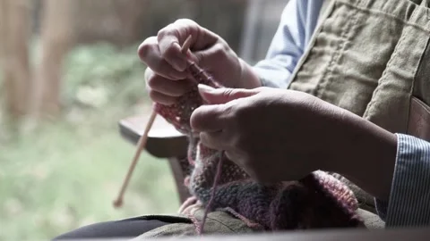 The hands of a middle-aged and elderly woman knitting Stock Footage 287973784