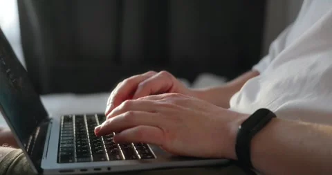 The hands of a millennial man opening a laptop, turning on a movie to watch Stock Footage 302901307