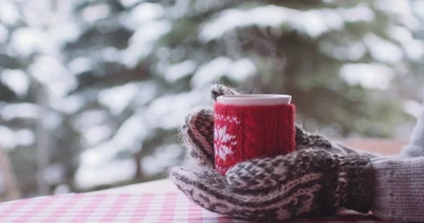 Hands in Mittens hold Steaming Cup of Hot Drink in Winter Day. 4K SLOW MOTION Stock Footage 67217966