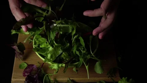 Hands mix mixed salad in a plate. Slow motion Stock Footage 74237778