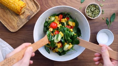 Hands mix summer vegetable salad Stock Footage 124264568