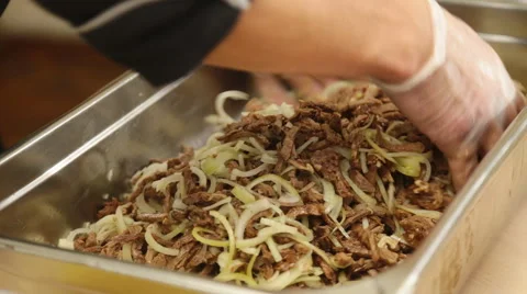 Hands mixed salad in a factory Stock Footage 60053503