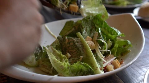 Hands mixing caesar salad Stock Footage 116797404