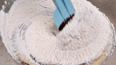 Hands mixing eggs, flour, melted chocolate and cocoa powder in bowl for brownies Stock Footage 158661027