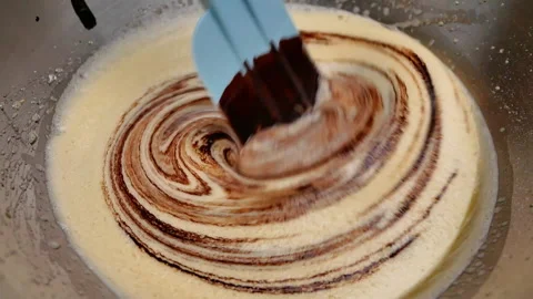 Hands mixing eggs, sugar, melted chocolate and cocoa powder in bowl for brownies Stock Footage 158660979