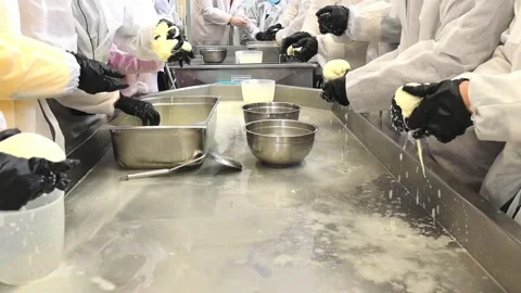 Hands mixing ingredients in a kitchen during a cooking class in an industrial se Stock Footage 325729833