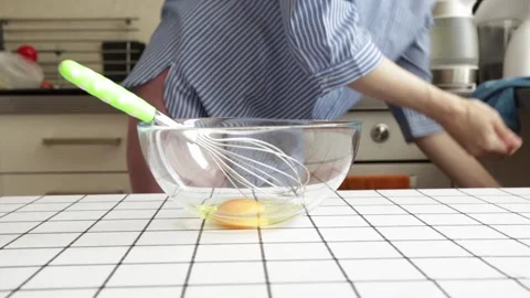 Hands mixing raw eggs in kitchen, close up of cooking process, ingredient p.. Stock Footage 317502449
